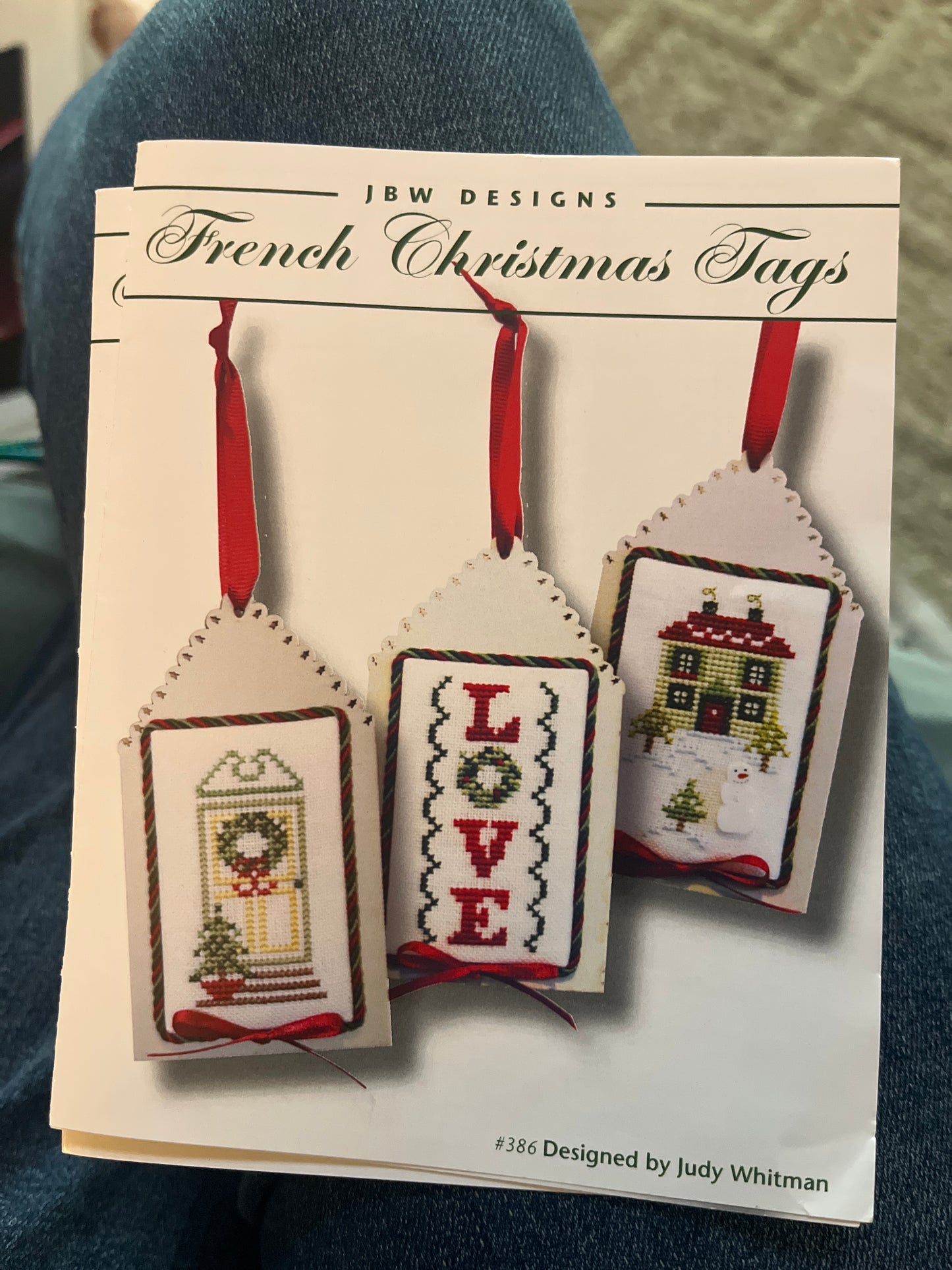 Cross-stitched Christmas tags on a card