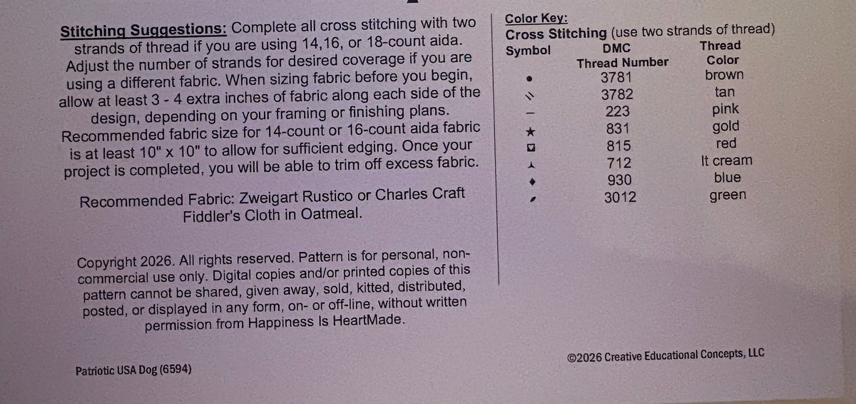 A printed instruction sheet showing cross-stitching symbols, thread numbers, thread colors, and stitching suggestions for cross-stitching. The sheet includes a table with symbols, thread numbers, thread colors, and a list of recommended fabrics.