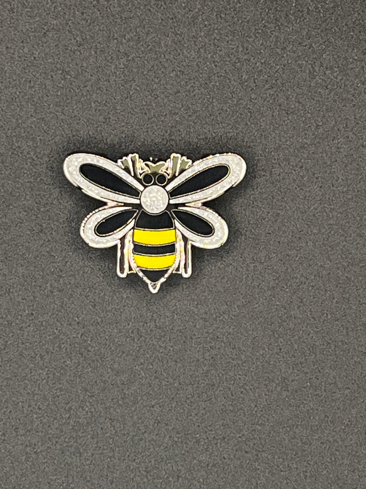 Bee-shaped needle minder on a gray background