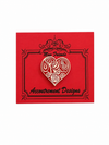 Red card with a heart design and 'Accoutrement Designs' text on a white background