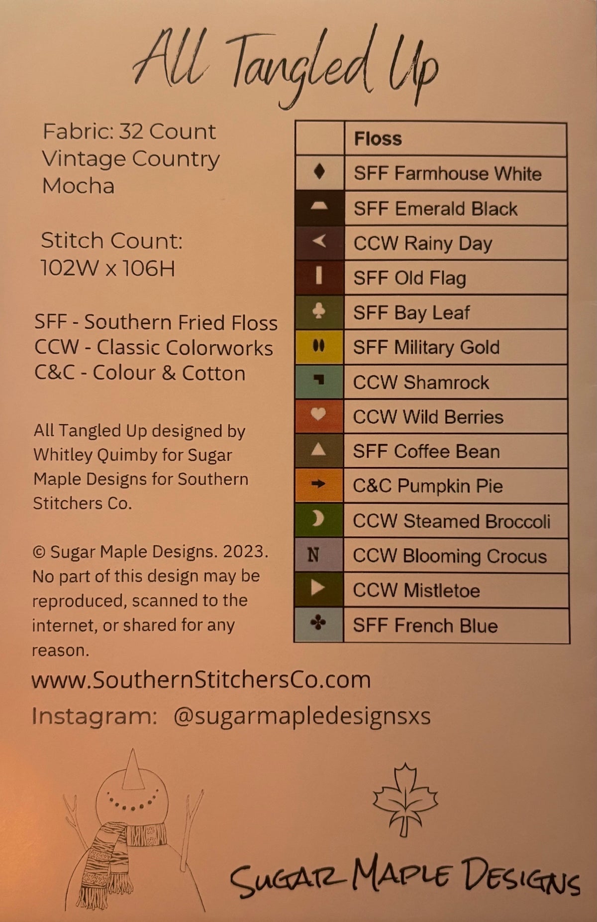 A fabric swatch and color reference card for 'All Tangled Up' quilting fabric by Sugar Maple Designs. The card features a color chart listing various shades of Southern Fried Floss (SFF) and Classic Colorworks (CCW) alongside fabric specifications: 32 count, vintage country mocha, and stitch count of 102W x 106H.