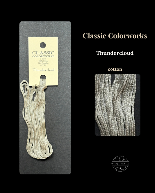  skein of yarn with packaging and close-up on a black background, featuring 'Classic Colorworks Thundercloud' label.