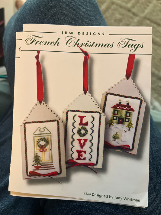 Cross-stitched Christmas tags on a card 