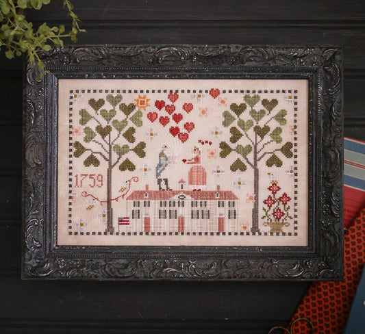 Framed cross-stitched piece with trees, hearts, and a house, featuring the year 1759.