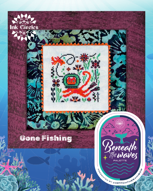 Cross-stitched design of a fish with floral elements on a patterned background, featuring 'Ink Circles' branding.