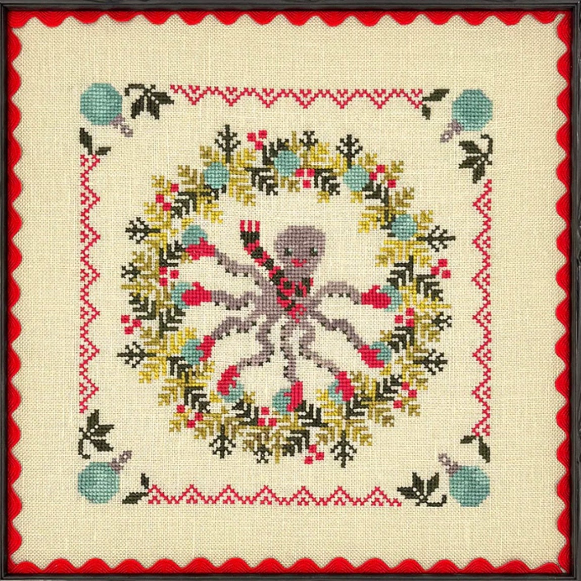 Cross-stitched design of an Octpus surrounded by a wreath
