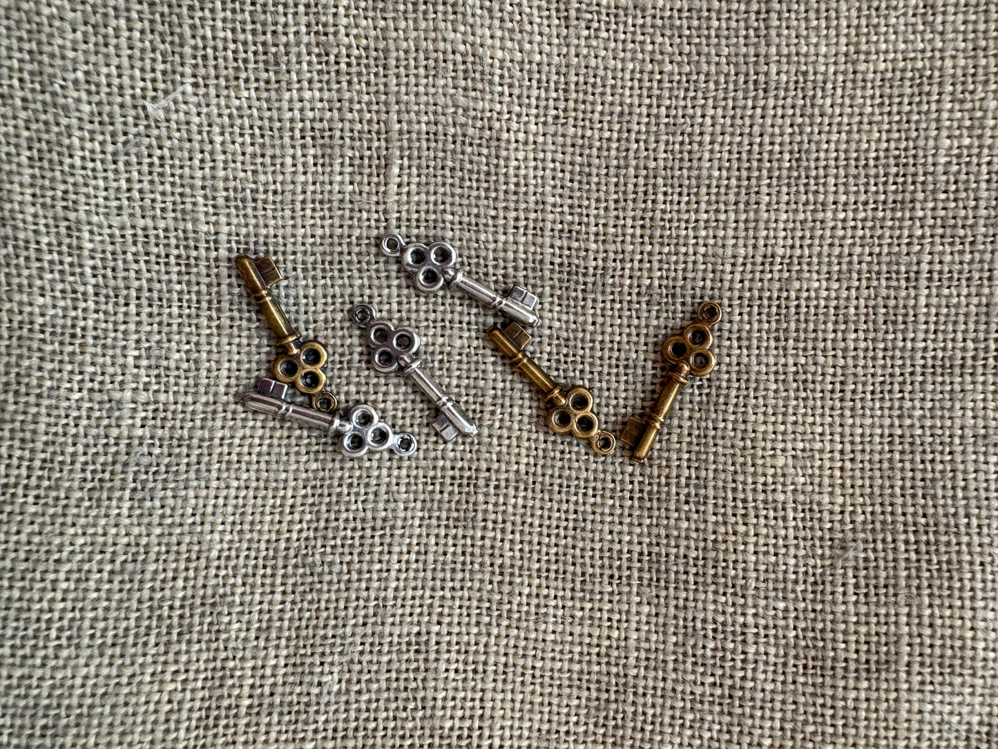 Collection of vintage-style keys on a textured fabric background