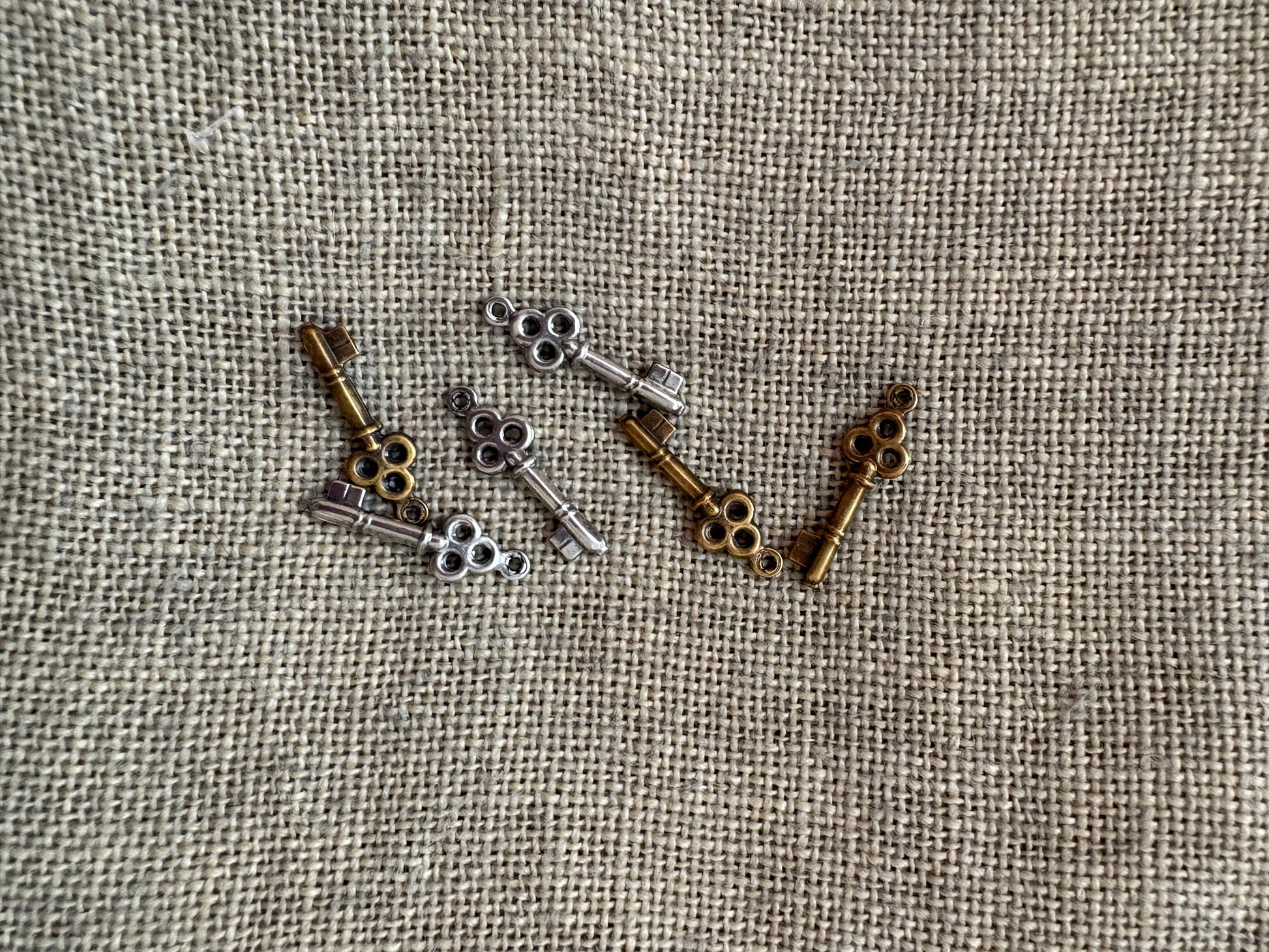 Collection of vintage-style keys on a textured fabric background