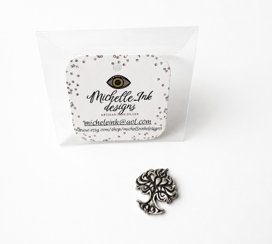 Silver tree of life pendant with packaging featuring 'Michelle Ink Designs' on a white background