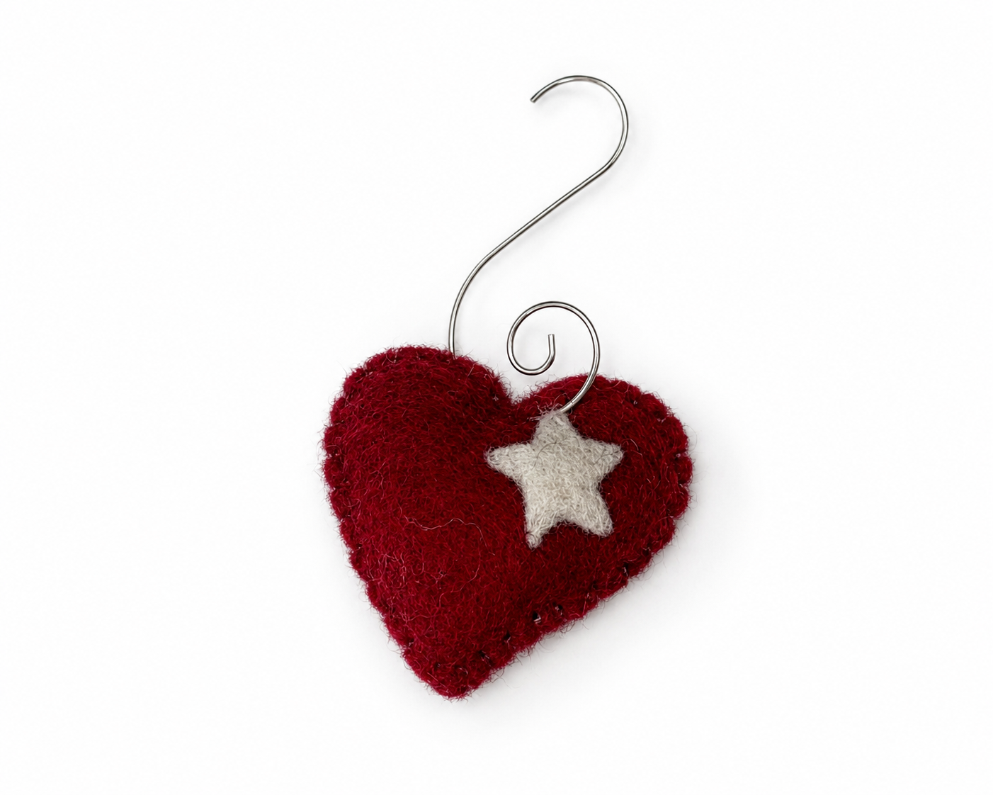 Red heart-shaped pin cushion ornament with a white star on a white background