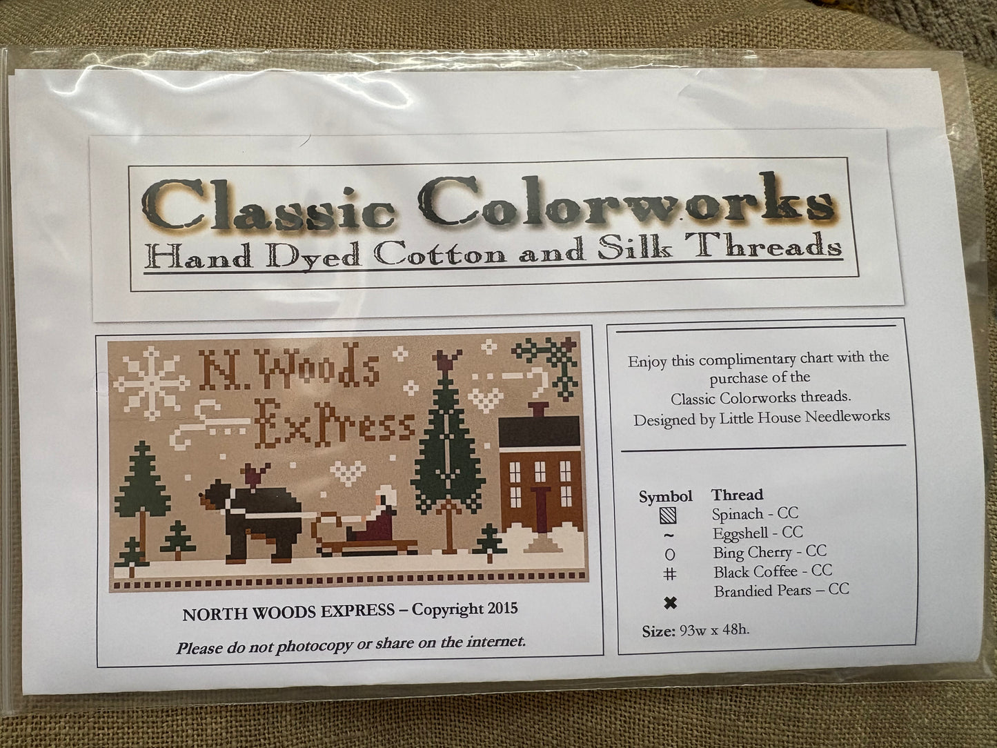 Package of Classic Colorworks hand dyed cotton and silk threads with a cross-stitch pattern for 'North Woods Express'.