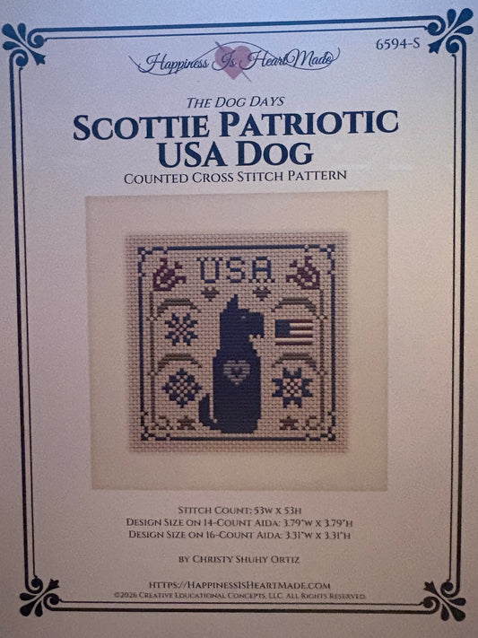 Front cover of a counted cross stitch pattern booklet titled 'The Dog Days: Scottie Patriotic USA Dog' by Happiness in a Frank Mead, showing a central stitched dog design on a cream background.