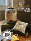 Decorative items with 'The Golden Apiary' branding on a wooden surface.