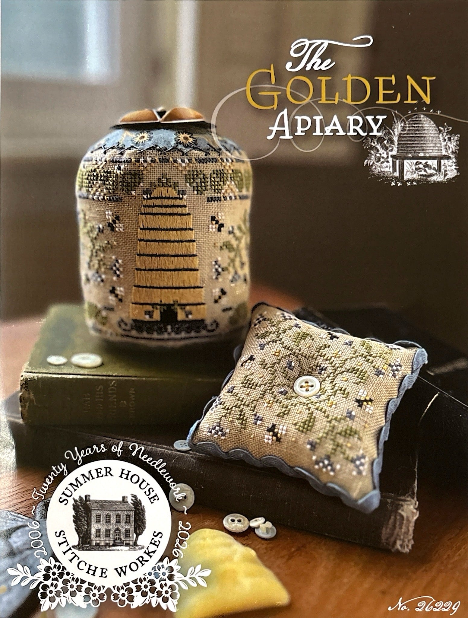 Decorative items with 'The Golden Apiary' branding on a wooden surface.