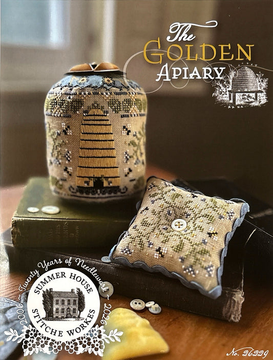 Decorative items with 'The Golden Apiary' branding on a wooden surface.