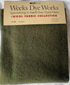 Green wool fabric with Weeks Dye Works label on a white background