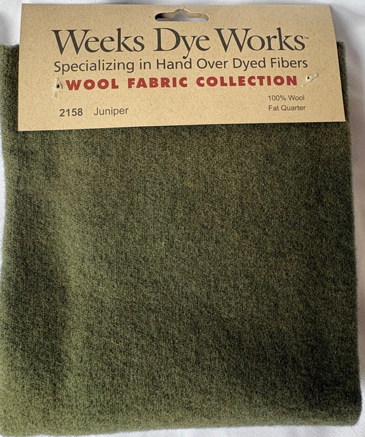 Green wool fabric with Weeks Dye Works label on a white background