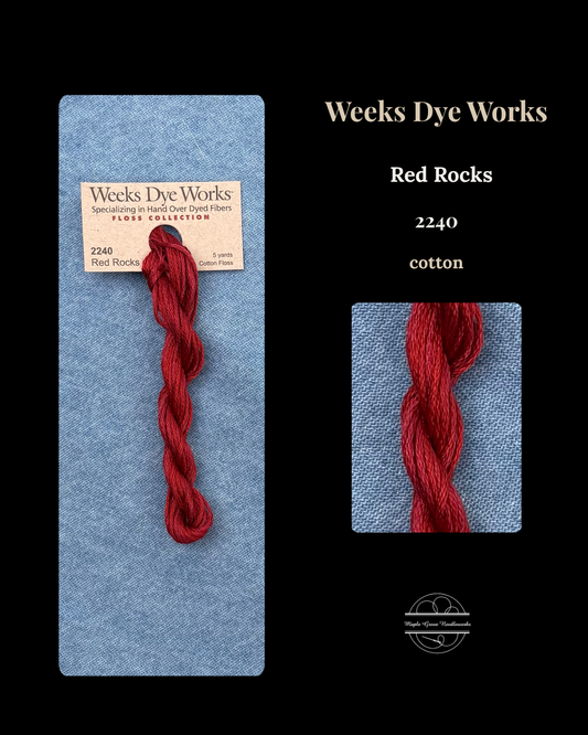 Red yarn skein with Weeks Dye Works label on a black background