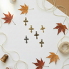 Cross charms on autumn background