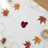 Medium cardinal button on autumn background
