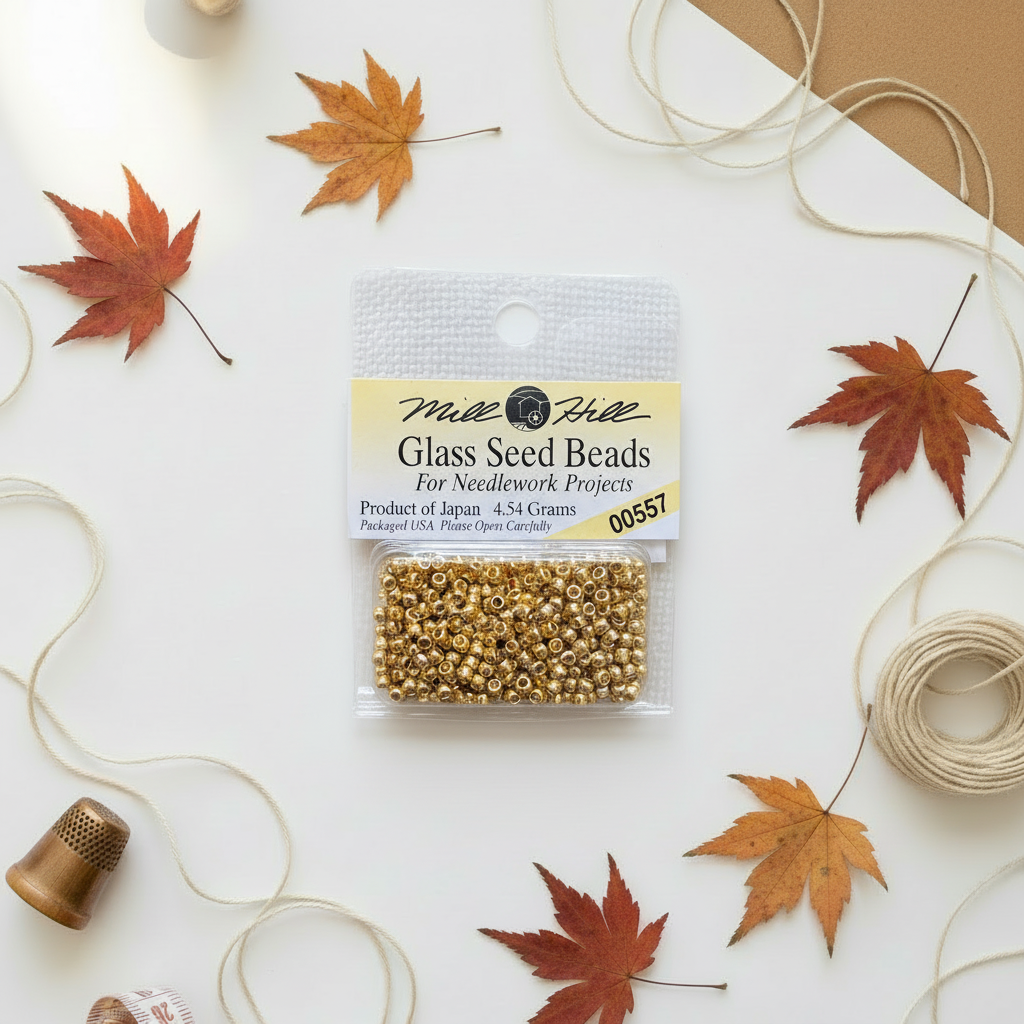 Mill Hill Old Gold Seed Beads on autumn background